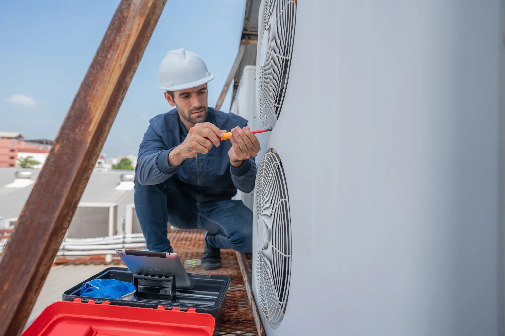 HVAC technician inspecting rooftop air conditioning equipment